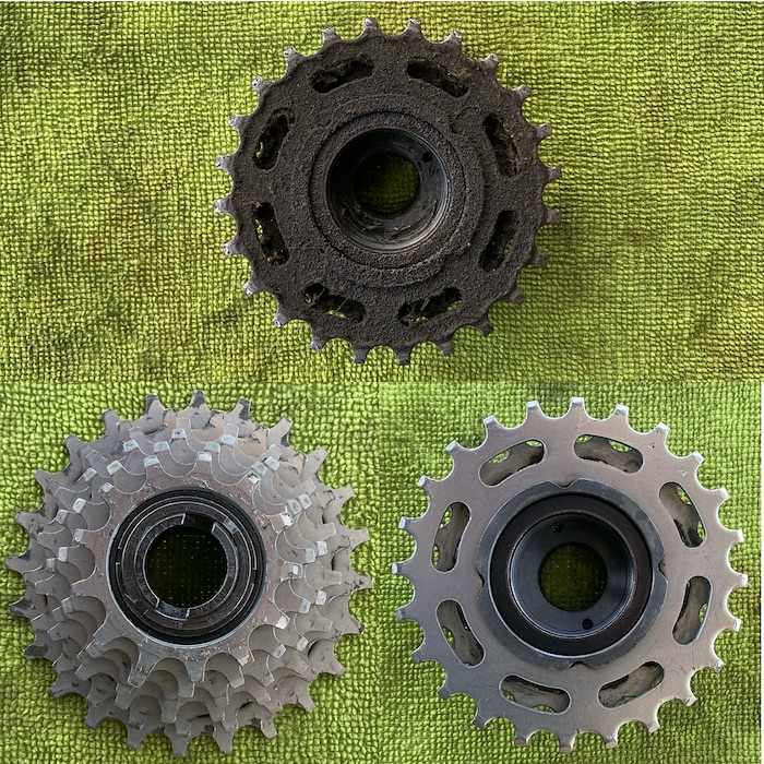 Filthy dirty freewheel (top) and nice shiny freewheel front (left) and back (right)