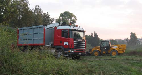 A truck and a bulldozer to remove the debris