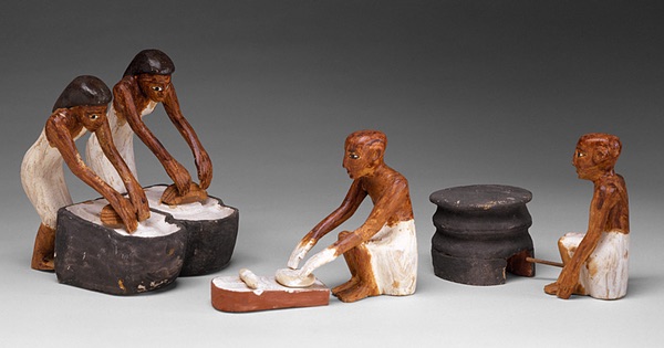 Miniature models of two women grinding flour, a man shaping loaves, and a man tending the oven. From a model in the tomb of Meketre, Metropolitan Musdeum of Art, Rogers Fund and Edward S. Harkness Gift, 1920